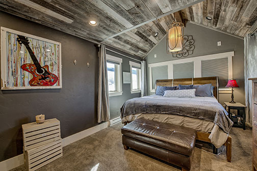 Bedroom with vaulted wood ceilings